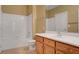 Bathroom featuring a tub with shower and wooden cabinets at 700 Carnegie St # 3711, Henderson, NV 89052