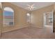 Bright, carpeted bedroom with arched windows and ceiling fan at 700 Carnegie St # 3711, Henderson, NV 89052