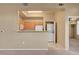 Kitchen and laundry area featuring white appliances and a breakfast bar overlooking living room at 700 Carnegie St # 3711, Henderson, NV 89052