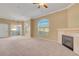 Spacious living room with a fireplace, neutral carpet, and large windows at 700 Carnegie St # 3711, Henderson, NV 89052