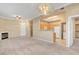 A view of a kitchen, with white appliances, next to a living room with a fireplace at 700 Carnegie St # 3711, Henderson, NV 89052