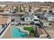 An aerial view of a home with a pool and mountain views, set in a peaceful residential neighborhood at 714 Arrowhead Trl, Henderson, NV 89002