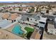 An aerial view of a home with a pool, well-maintained landscaping, and mountain views, set in a residential neighborhood at 714 Arrowhead Trl, Henderson, NV 89002