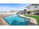 A backyard featuring a pool, patio with furniture, and a well-maintained lawn, perfect for outdoor entertaining at 714 Arrowhead Trl, Henderson, NV 89002