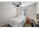 Bedroom with ceiling fan, carpet, window and white bedding at 714 Arrowhead Trl, Henderson, NV 89002