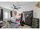 Bright bedroom with dark ceiling fan, carpet, window and athletic decor at 714 Arrowhead Trl, Henderson, NV 89002