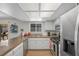 Well-lit kitchen with stainless steel appliances, light wood floors and tile countertops at 714 Arrowhead Trl, Henderson, NV 89002