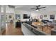 Open-concept living room with hard surface flooring, neutral walls, ceiling fan and modern furnishings at 714 Arrowhead Trl, Henderson, NV 89002