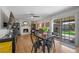 Bright living area with white-painted brick fireplace, hard surface floors, ceiling fan and sliding door to backyard at 714 Arrowhead Trl, Henderson, NV 89002