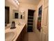 Bathroom featuring dual sinks, white countertops, and decorative accents at 7511 Shadow Estates Way, Las Vegas, NV 89113