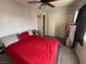 Bedroom with a ceiling fan, closet, and a bed with a red comforter at 7511 Shadow Estates Way, Las Vegas, NV 89113