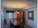 Formal dining room with wood table, chandelier, and built-in hutch at 7511 Shadow Estates Way, Las Vegas, NV 89113