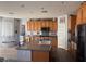 Kitchen with a large island, stainless steel appliances, light-colored cabinets and a small bench at 7511 Shadow Estates Way, Las Vegas, NV 89113