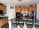 Kitchen with a large island, stainless steel appliances, light-colored cabinets and seating at 7511 Shadow Estates Way, Las Vegas, NV 89113