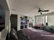 Living room featuring a fireplace, tv, ceiling fan, and large windows at 7511 Shadow Estates Way, Las Vegas, NV 89113