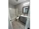 Well-lit bathroom with a gray vanity, framed mirror, and a shower over tub with white subway tile at 7732 Hand Woven Ct, Las Vegas, NV 89149