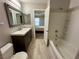 Bathroom featuring a modern vanity, tub/shower combination and plank flooring at 7732 Hand Woven Ct, Las Vegas, NV 89149