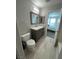 Well-lit bathroom with a gray vanity, contemporary fixtures, and plank flooring at 7732 Hand Woven Ct, Las Vegas, NV 89149