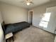 A bedroom with neutral-colored walls, carpeted floors, and a ceiling fan with light fixture at 7732 Hand Woven Ct, Las Vegas, NV 89149