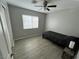 Bright bedroom features modern ceiling fan, window, and wood-look laminate flooring at 7732 Hand Woven Ct, Las Vegas, NV 89149