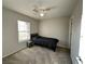 Cozy bedroom with neutral walls, carpeted floors, and a ceiling fan with an attached light fixture at 7732 Hand Woven Ct, Las Vegas, NV 89149