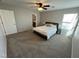 Bedroom with carpet, a ceiling fan, and a view of the en-suite bath at 7732 Hand Woven Ct, Las Vegas, NV 89149