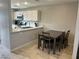 Bright dining area with modern kitchen, table, and chairs at 7732 Hand Woven Ct, Las Vegas, NV 89149