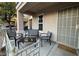 Cozy front porch featuring a seating area with chairs and a table, perfect for relaxing outdoors at 7732 Hand Woven Ct, Las Vegas, NV 89149