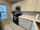 Bright kitchen with stainless steel oven/microwave and white countertops and cabinets at 7732 Hand Woven Ct, Las Vegas, NV 89149