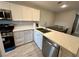 Modern kitchen featuring white cabinetry, stainless steel appliances, and a sleek countertop at 7732 Hand Woven Ct, Las Vegas, NV 89149