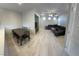 Spacious living room with L-shaped sectional sofa, coffee table, and ceiling fan at 7732 Hand Woven Ct, Las Vegas, NV 89149