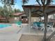 View of the pool area, featuring a covered picnic area, lounge chairs under a cloudy sky at 7732 Hand Woven Ct, Las Vegas, NV 89149