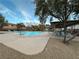 Community pool area, featuring a covered seating area, with lounge chairs around the pool under a sunny sky at 7732 Hand Woven Ct, Las Vegas, NV 89149