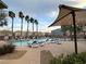 Community pool area with rows of lounge chairs and palm trees, perfect for relaxation and leisure at 7732 Hand Woven Ct, Las Vegas, NV 89149