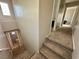 Carpeted staircase leading to the second floor, with a view of the downstairs bathroom at 7732 Hand Woven Ct, Las Vegas, NV 89149