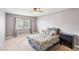 Spacious bedroom with a queen bed and ceiling fan at 7987 Cina Ave, Las Vegas, NV 89147