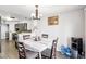 Dining area with table and chairs, water cooler, and kitchen access at 7987 Cina Ave, Las Vegas, NV 89147