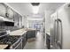 Modern kitchen with stainless steel appliances and gray cabinets at 7987 Cina Ave, Las Vegas, NV 89147