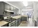 Modern kitchen with stainless steel appliances and gray cabinets at 7987 Cina Ave, Las Vegas, NV 89147