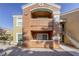 Two-story building with tan and orange exterior, balconies, and stairs at 8101 W Flamingo Rd # 1157, Las Vegas, NV 89147