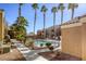 Community pool with palm trees and a surrounding patio at 8101 W Flamingo Rd # 1157, Las Vegas, NV 89147