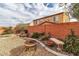 Landscaped backyard with fire pit and bench at 825 Great Sky Ct, North Las Vegas, NV 89084