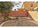 Private backyard with gravel and a wood pile at 825 Great Sky Ct, North Las Vegas, NV 89084