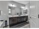 Elegant bathroom with a double vanity, large mirror, and dark brown cabinets at 825 Great Sky Ct, North Las Vegas, NV 89084