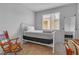 Simple bedroom with a white metal bed frame and rocking chair at 825 Great Sky Ct, North Las Vegas, NV 89084