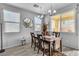 Bright dining room with a wood table and chairs, and large windows at 825 Great Sky Ct, North Las Vegas, NV 89084