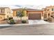 One-story house with brown garage door and landscaped yard at 825 Great Sky Ct, North Las Vegas, NV 89084