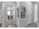 Hallway with gray tile floors and framed artwork, looking into an office at 825 Great Sky Ct, North Las Vegas, NV 89084