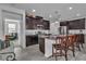 Modern kitchen with dark cabinets, granite countertops, and stainless steel appliances at 825 Great Sky Ct, North Las Vegas, NV 89084