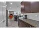 Kitchen with dark cabinets, granite countertops and white backsplash at 825 Great Sky Ct, North Las Vegas, NV 89084